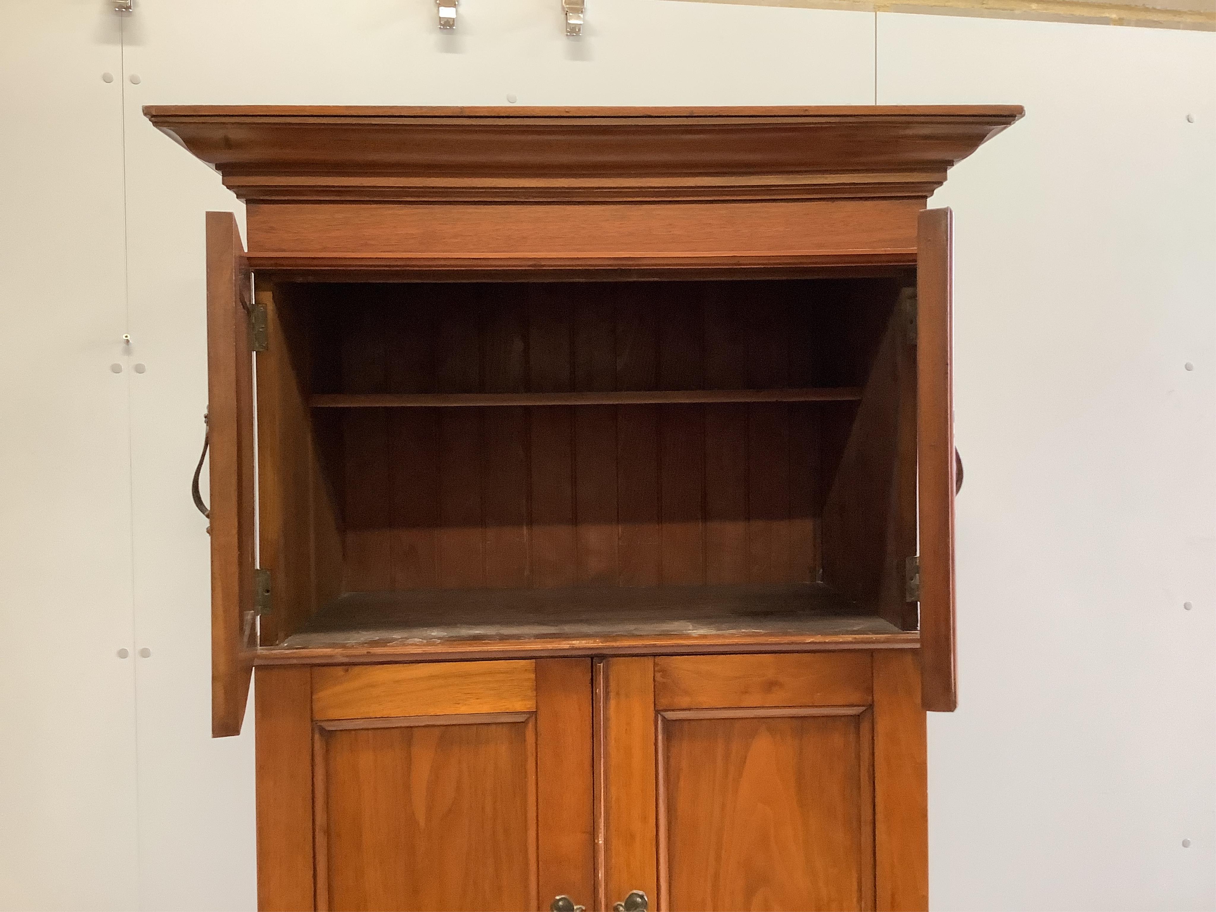 An Art Nouveau walnut gentleman's compactum wardrobe, width 77cm, depth 44cm, height 198cm. Condition - fair to good